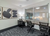 Thumbnail 31 of 33 - a conference room with a desk and chairs and a window