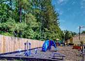 Thumbnail 13 of 16 - Playground at Broad on the Green in Augusta, GA, featuring play structures and outdoor recreational space