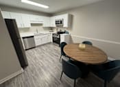 Thumbnail 3 of 29 - Twin Oaks Apartments in Hattiesburg Mississippi photo of kitchen with a table and chairs.