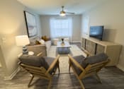 Thumbnail 9 of 29 - Twin Oaks Apartments in Hattiesburg Mississippi A living room with two chairs and a couch.