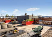 Thumbnail 20 of 20 - A patio with a table, chairs, and a couch.