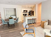 Thumbnail 4 of 35 - A modern kitchen with a dining table and chairs.
