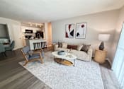 Thumbnail 5 of 35 - A living room with a grey rug and a white couch.