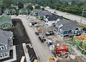 Thumbnail 12 of 14 - A construction site with multiple houses under construction.