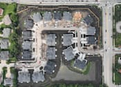 Thumbnail 10 of 14 - A construction site is surrounded by houses.