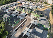 Thumbnail 9 of 14 - A construction site in a residential area with a road running through it.