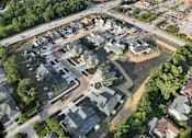Thumbnail 3 of 14 - A bird's eye view of a residential area with houses and a road.