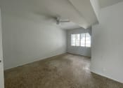 Thumbnail 12 of 12 - an empty bedroom with a ceiling fan and a window