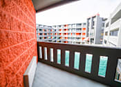 Thumbnail 38 of 51 - A balcony with a red wall and a view of the sea.