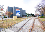 Thumbnail 47 of 51 - A railroad track with a sign that says "PASSENGER FLATS" on the side of it.