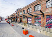 Thumbnail 51 of 51 - A brick building with a sign that says "World Peace" on it.