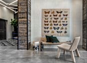Thumbnail 11 of 20 - A modern living room with a large poster of butterflies on the wall.