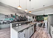 Thumbnail 38 of 42 - A modern kitchen with a cityscape mural on the wall.