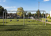 Thumbnail 30 of 42 - A playground with swings and a seesaw in the foreground.