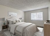 Thumbnail 10 of 42 - Aurora, CO Apartments – Ivy Crossing – A bedroom with a large bed and a nightstand with a lamp.