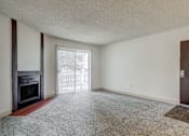 Thumbnail 25 of 42 - Aurora, CO Apartments – Ivy Crossing – A room with a fireplace and a door.