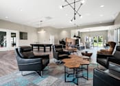 Thumbnail 39 of 42 - A modern living room with black leather furniture and a wooden coffee table.