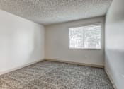 Thumbnail 27 of 42 - A room with a carpeted floor and a window with blinds.