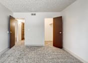 Thumbnail 28 of 42 - A room with a carpeted floor and two doors.
