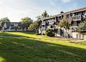 Thumbnail 40 of 42 - A row of apartment buildings with green lawns in front.