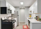 Thumbnail 1 of 14 - Stratford Wood Apartments and Townhomes in Minnetonka, MN Photo of kitchen with white cabinets and stainless steel appliances