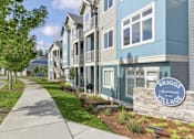 Thumbnail 18 of 26 - A row of townhouses with a sign that says Briggs Apartments Village.