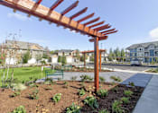 Thumbnail 22 of 26 - A large wooden structure is in the foreground of a residential area.