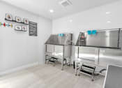 Thumbnail 40 of 43 - A clean, empty commercial kitchen with stainless steel appliances and white walls.