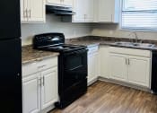 Thumbnail 1 of 13 - The Element at 4411 Macon, GA Apartment Black appliances Kitchen alternate view