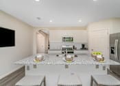 Thumbnail 15 of 35 - A kitchen with a granite countertop and stainless steel appliances.