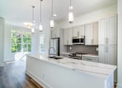 Thumbnail 2 of 13 - Pet-Friendly Homes In Edgewood, GA – LaFrance Square- A modern kitchen with white countertops and stainless steel appliances.