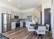 Thumbnail 10 of 13 - Luxury Atlanta, GA Homes – LaFrance Square – A modern kitchen with a dining table set for two.
