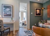 Thumbnail 6 of 13 - Luxury Homes In Atlanta, GA 30307 for Rent – LaFrance Square – A living room with a brown chair and a white couch.