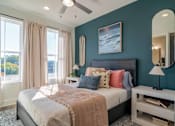 Thumbnail 8 of 13 - Pet-Friendly Homes In Edgewood, GA – LaFrance Square- A bedroom with a large bed and a ceiling fan.