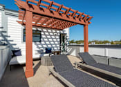 Thumbnail 11 of 13 - Pet-Friendly Homes In Edgewood, GA – LaFrance Square- A patio with a pergola and lounge chairs.