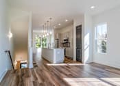 Thumbnail 3 of 13 - Luxury Homes In Atlanta, GA 30307 for Rent – LaFrance Square – A modern kitchen with wooden floors and a large island.
