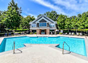 Thumbnail 2 of 17 - A large swimming pool in front of a house.