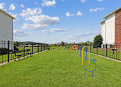 Thumbnail 13 of 25 - Pet-friendly bark park at Lancaster Place Apartments in Calera, Alabama with fenced play areas and agility equipment for resident pets.