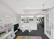 Thumbnail 17 of 25 - Children's activity room at Lancaster Place Apartments in Calera, AL featuring a colorful play area for younger residents.