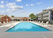 Thumbnail 8 of 25 - Resort-style swimming pool at Lancaster Place Apartments in Calera, AL with spacious sundeck and lounge seating near Shelby County and I-65.