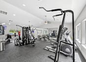 Thumbnail 15 of 25 - Modern fitness center at Lancaster Place Apartments in Calera, AL with strength training equipment and cardio machines for residents.