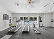 Thumbnail 3 of 25 - Bright resident fitness center at Lancaster Place Apartments in Calera, Alabama featuring treadmills, weight equipment, and spacious workout areas.
