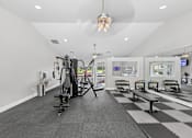 Thumbnail 14 of 25 - Fully equipped apartment fitness center at Lancaster Place Apartments in Calera, AL with free weights, cardio equipment, and natural light.