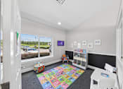 Thumbnail 16 of 25 - Children's activity room at Lancaster Place Apartments in Calera, AL featuring a colorful play area for younger residents.