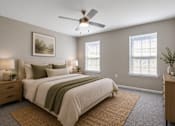 Thumbnail 6 of 25 - Spacious primary bedroom at Lancaster Place Apartments in Calera, Alabama featuring large windows, neutral finishes, and abundant natural light.