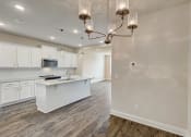 Thumbnail 5 of 16 - a kitchen and living room with a chandelier