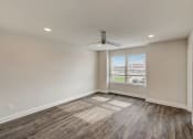 Thumbnail 10 of 16 - 3 BR Townhomes in Gallatin TN - The Gardens at Preston Park - Unfurnished Bedroom with Hardwood Flooring, Window, and Celing Fan