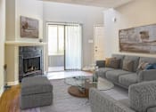 Thumbnail 1 of 16 - Greentree Apartments in Savannah, GA photo of a living room with a couch and a table and a fireplace