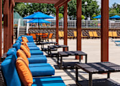 Thumbnail 9 of 14 - Poolside lounge seating with shaded pergola in Stockbridge GA apartment community