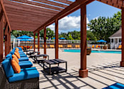 Thumbnail 10 of 14 - Covered pergola seating area at Stockbridge GA apartment community with pool views
